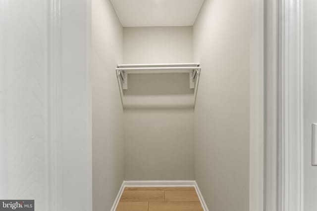 walk in closet featuring hardwood / wood-style flooring