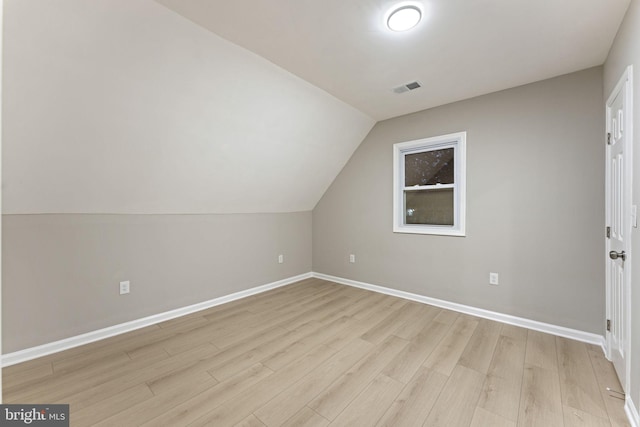 bonus room featuring light wood-type flooring and lofted ceiling