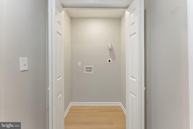 washroom with hookup for a washing machine, light hardwood / wood-style floors, and hookup for an electric dryer