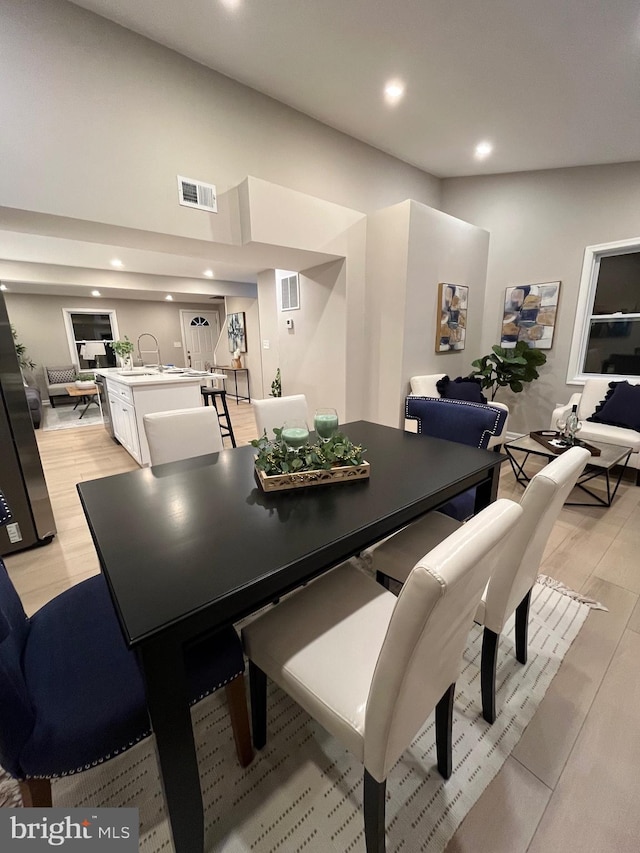 dining room with light hardwood / wood-style flooring and sink