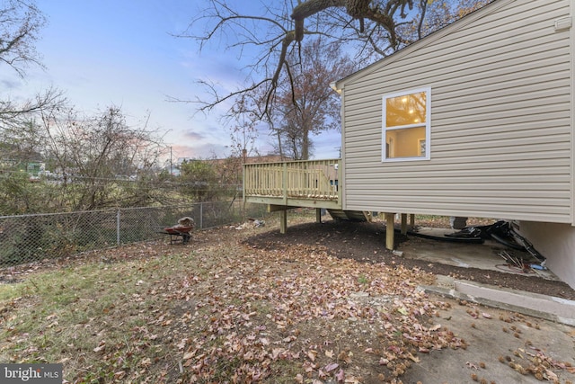 yard at dusk with a deck