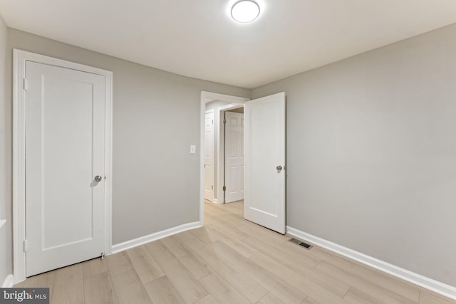 unfurnished bedroom featuring light wood-type flooring