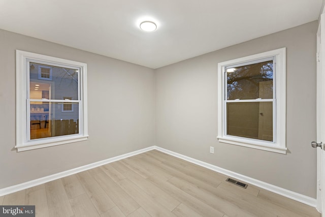 empty room with light hardwood / wood-style flooring