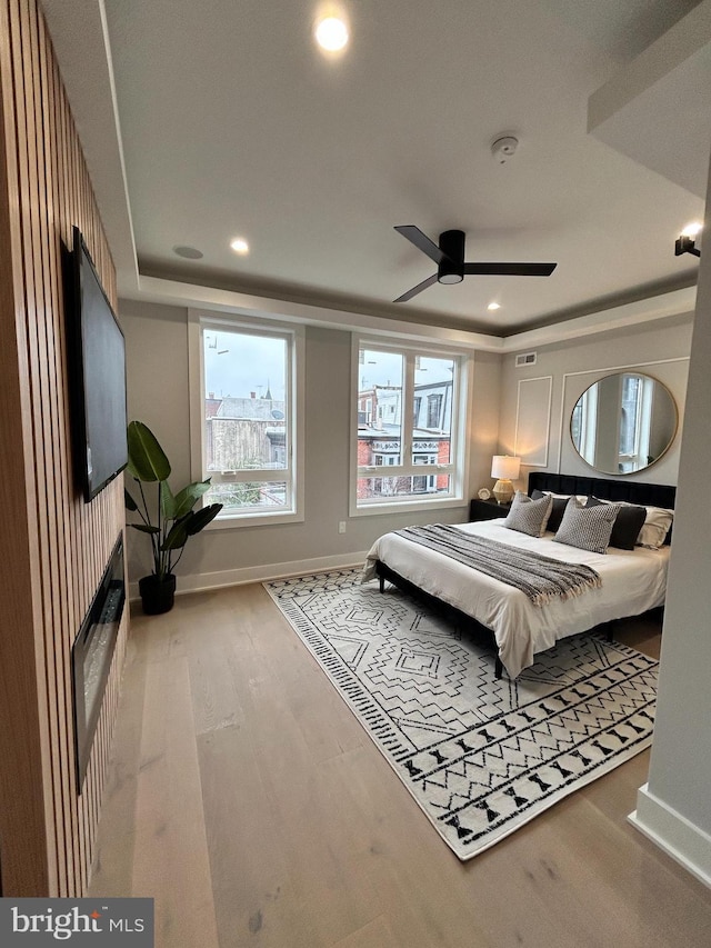 bedroom with ceiling fan and wood-type flooring