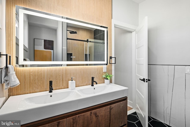 bathroom with tile patterned floors, a shower with door, and vanity