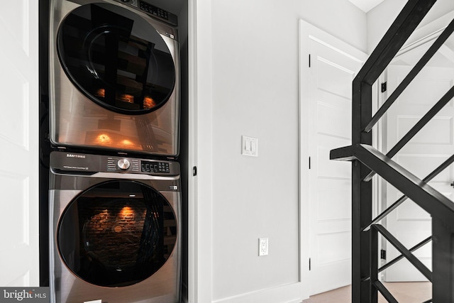 clothes washing area featuring stacked washer and dryer