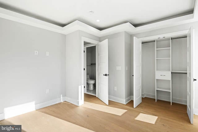 unfurnished bedroom with wood-type flooring and a closet