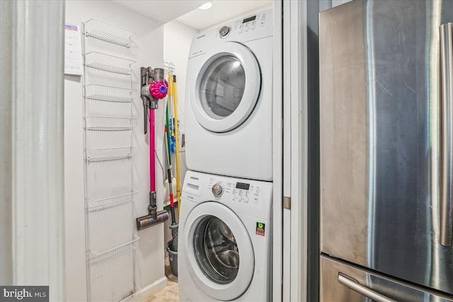 laundry room with stacked washing maching and dryer