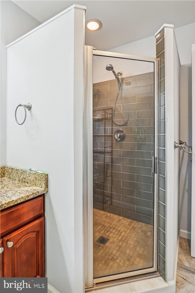 bathroom featuring tile patterned floors, vanity, and walk in shower