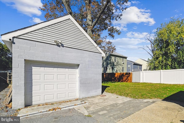 garage featuring a lawn