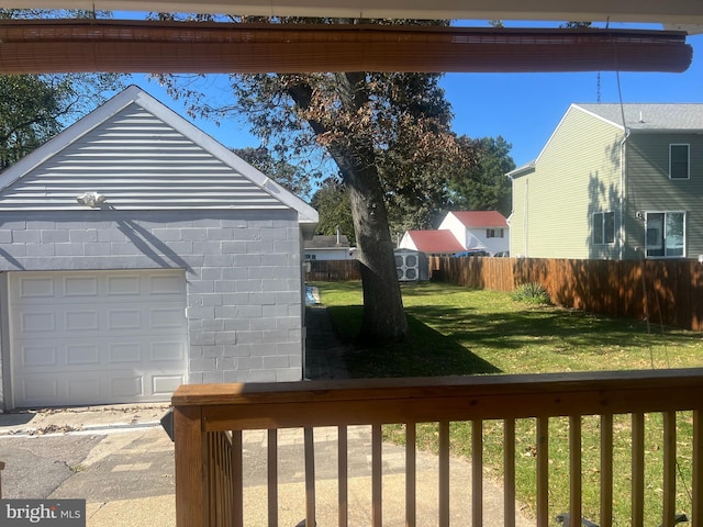 view of yard featuring a storage unit and a garage