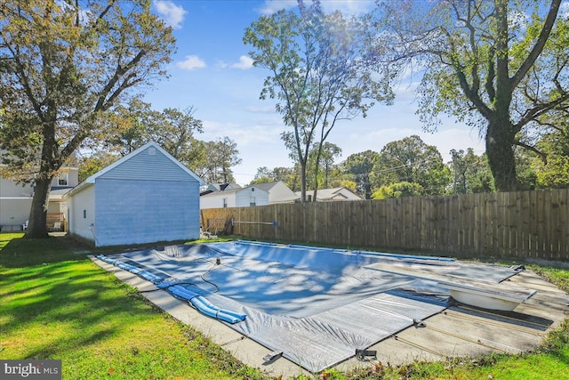 view of pool featuring a yard