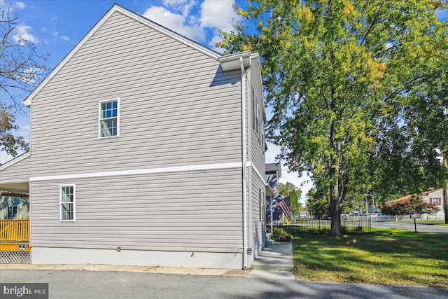 view of side of property with a yard