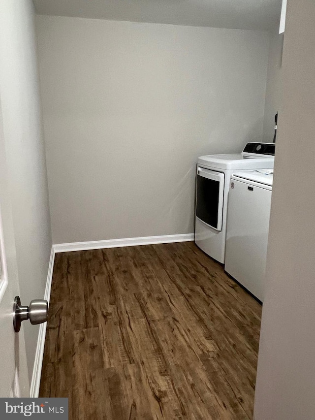 laundry room with dark hardwood / wood-style floors and separate washer and dryer