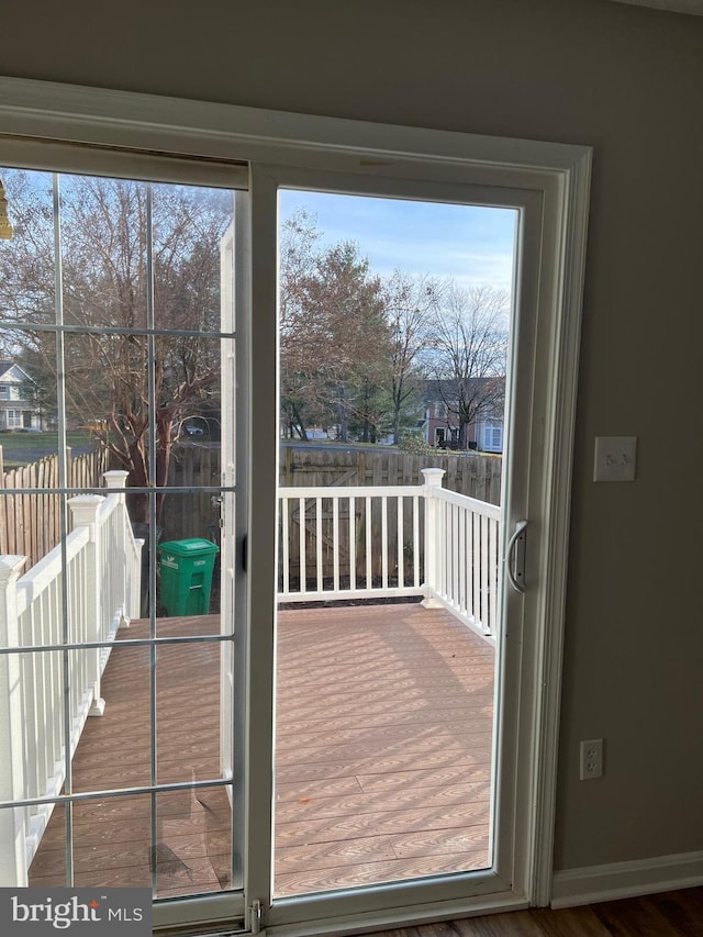 doorway with a healthy amount of sunlight and hardwood / wood-style flooring