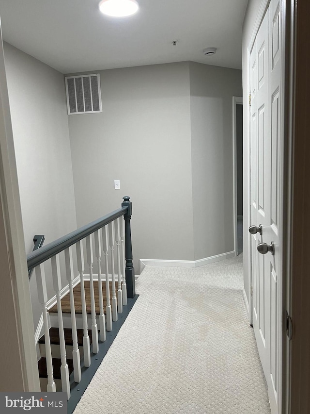 corridor with light colored carpet