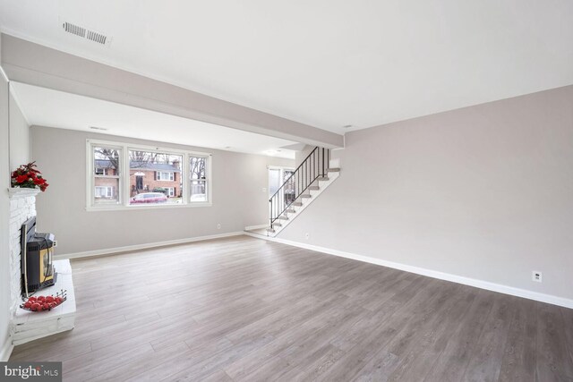 unfurnished living room with wood-type flooring