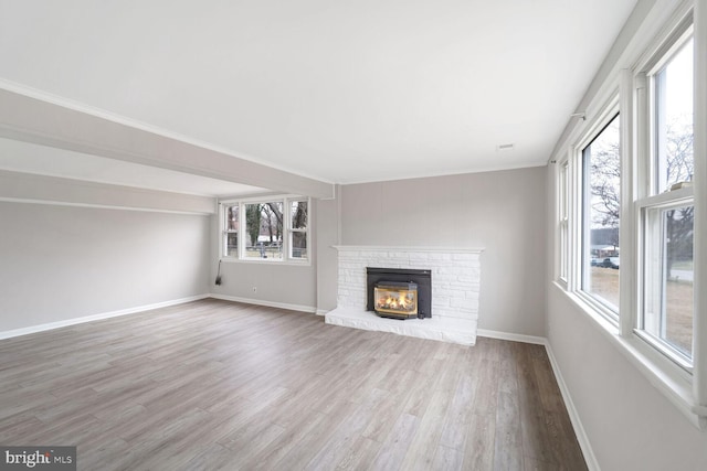 unfurnished living room with a fireplace and hardwood / wood-style flooring