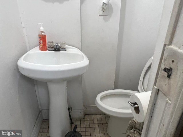 bathroom with tile patterned floors and toilet