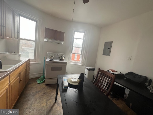 kitchen with electric range oven, sink, and electric panel