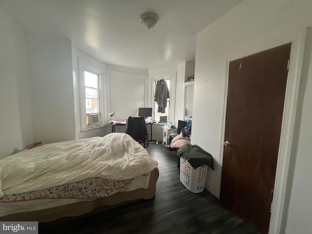 bedroom featuring dark hardwood / wood-style flooring and cooling unit