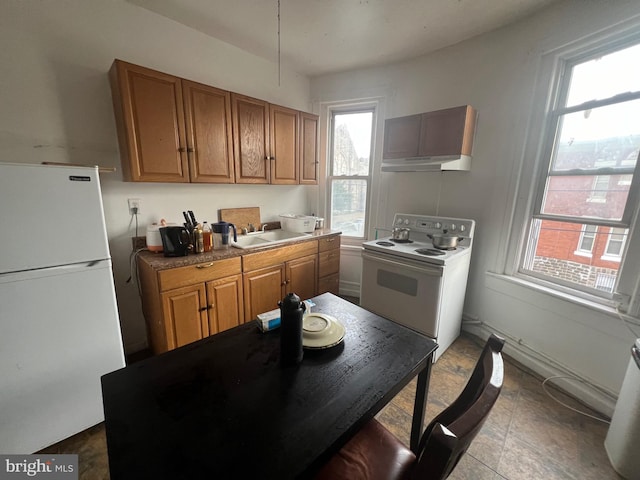 kitchen with tile patterned floors, sink, a healthy amount of sunlight, and white appliances