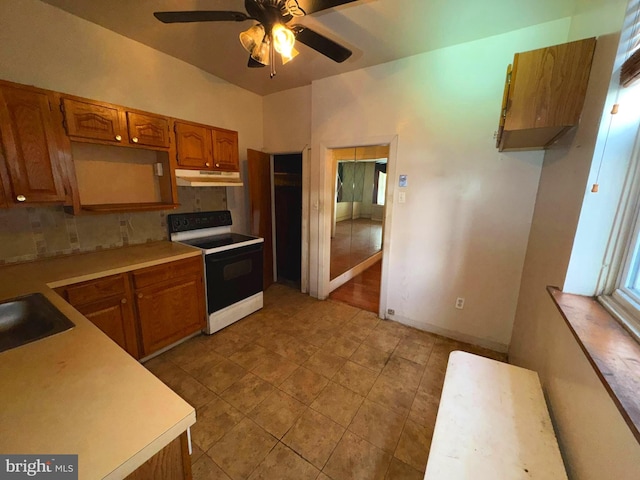 kitchen featuring decorative backsplash, ceiling fan, sink, light tile patterned floors, and white electric stove