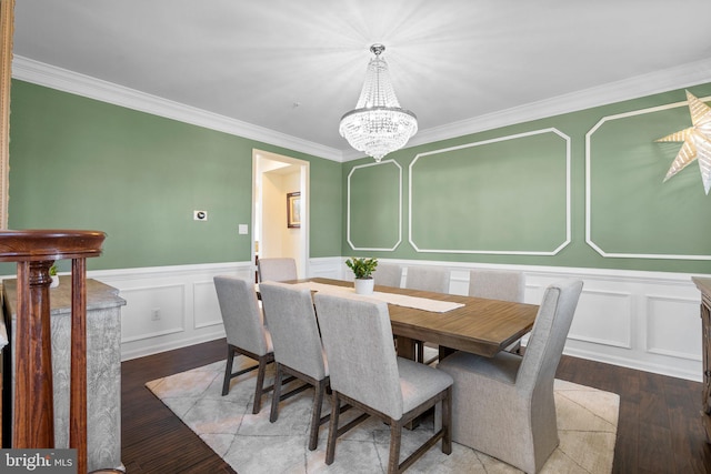 6616 Osborne Hill Dr, Upper Marlboro, MD 20772 - dining area featuring a decorative wall, ornamental molding, hardwood / wood-style flooring, a chandelier, and a wainscoted wall