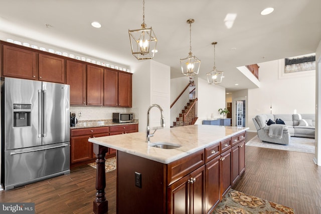 6616 Osborne Hill Dr, Upper Marlboro, MD 20772 - kitchen featuring appliances with stainless steel finishes, a sink, tasteful backsplash, dark wood-style floors, and pendant lighting