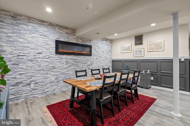 6616 Osborne Hill Dr, Upper Marlboro, MD 20772 - dining space with a wainscoted wall, light wood finished floors, decorative columns, a decorative wall, and recessed lighting