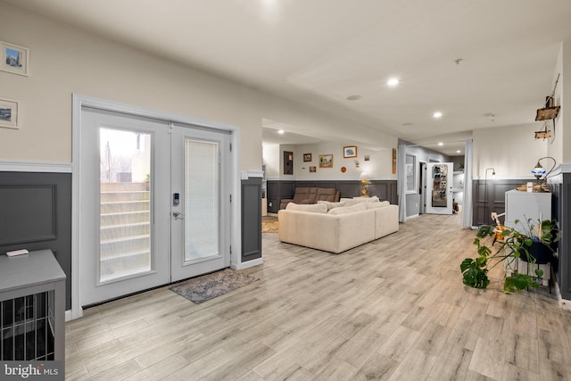 6616 Osborne Hill Dr, Upper Marlboro, MD 20772 - living room featuring french doors, light wood finished floors, wainscoting, recessed lighting, and a decorative wall