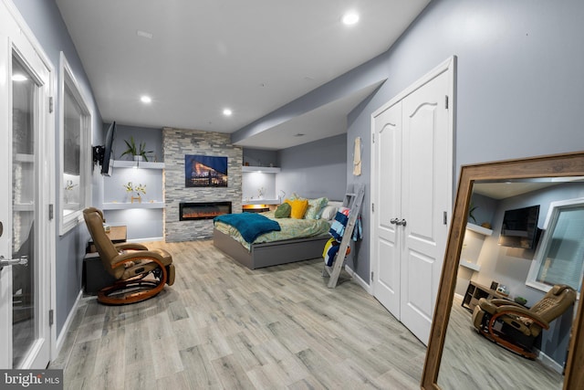 6616 Osborne Hill Dr, Upper Marlboro, MD 20772 - living room with wood finished floors, recessed lighting, a stone fireplace, and baseboards
