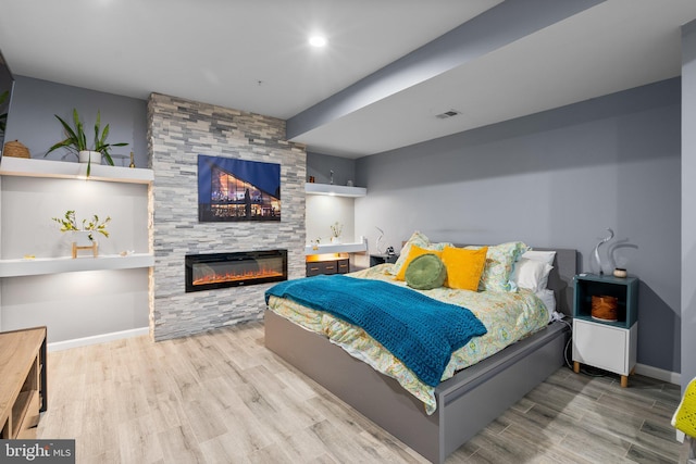 6616 Osborne Hill Dr, Upper Marlboro, MD 20772 - bedroom featuring wood finished floors, a fireplace, and baseboards