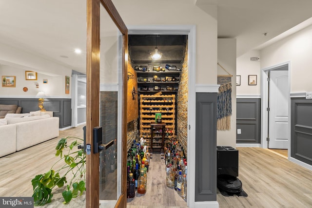 6616 Osborne Hill Dr, Upper Marlboro, MD 20772 - wine cellar featuring a wainscoted wall, wood finished floors, and a decorative wall