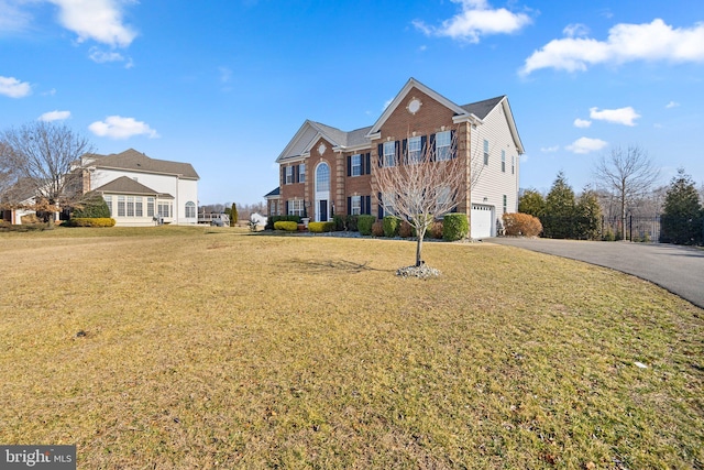 6616 Osborne Hill Dr, Upper Marlboro, MD 20772 - colonial inspired home with a garage, driveway, a front yard, and brick siding
