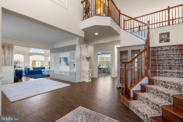 6616 Osborne Hill Dr, Upper Marlboro, MD 20772 - entryway featuring stairway, wood finished floors, a high ceiling, baseboards, and arched walkways
