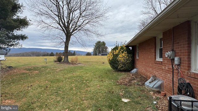 view of yard featuring a mountain view, cooling unit, and a rural view