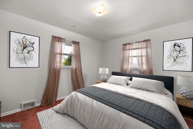 carpeted bedroom featuring multiple windows