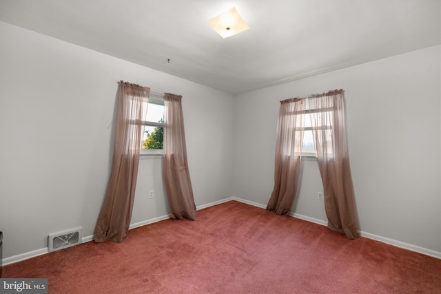 spare room featuring carpet floors and plenty of natural light