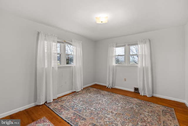 spare room with hardwood / wood-style flooring