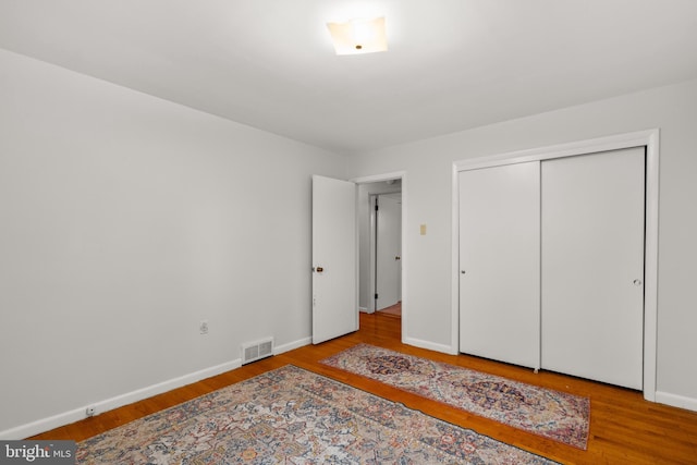 bedroom featuring light wood-type flooring and a closet