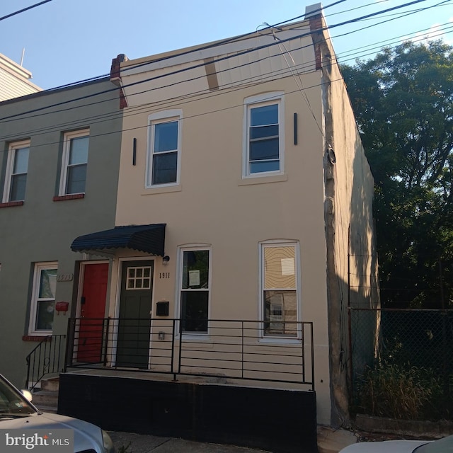 multi unit property featuring fence and stucco siding