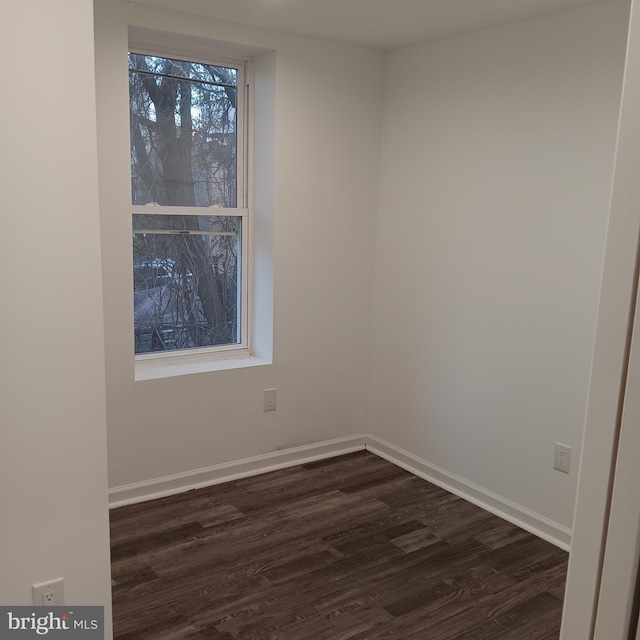 spare room with dark hardwood / wood-style flooring