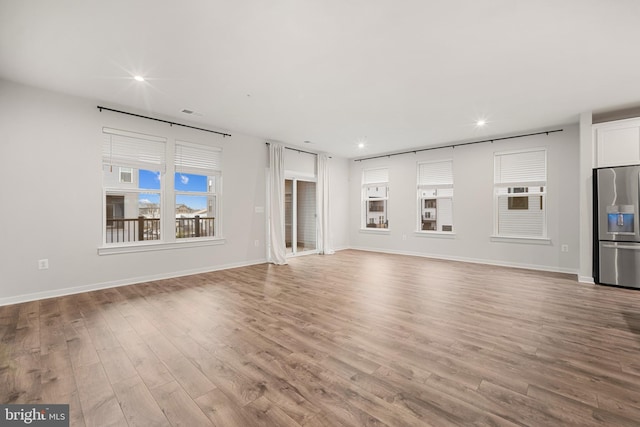 unfurnished living room with light hardwood / wood-style flooring