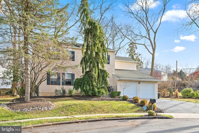 view of front facade with a front yard and a garage