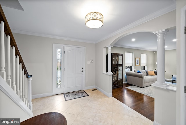 foyer with light wood-type flooring and crown molding