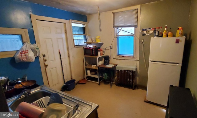 kitchen featuring white refrigerator and radiator