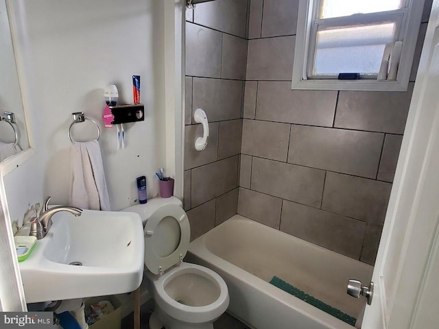 full bathroom featuring toilet, sink, and tiled shower / bath