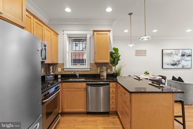 kitchen featuring pendant lighting, a kitchen breakfast bar, appliances with stainless steel finishes, light hardwood / wood-style floors, and kitchen peninsula