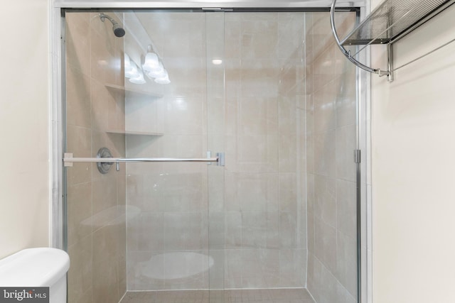 bathroom featuring a shower with door